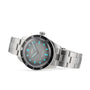 The Oris Divers Sixty‑Five is a stainless steel wristwatch featuring a black bezel and glowing blue hour markers on a gray dial.