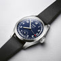 The Oris Big Crown Pointer Date Calibre 403 features a stainless steel case, black leather strap, dark blue dial with Arabic numerals, and three hands including a red-tipped pointer for the date.
