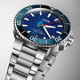 The Oris Aquis Sun Wukong Limited Edition is a stainless steel dive watch featuring a blue dial, unidirectional bezel, luminous hands and markers, and a date display at 6 o’clock.
