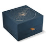 A dark blue limited edition Oris box features gold Monkey King line art and a radial lid pattern, plus a tan pull tab—created for the Oris Aquis Sun Wukong Limited Edition.