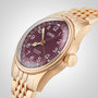 The Oris Big Crown Bronze Pointer Date is a gold wristwatch with a burgundy dial and a matching gold bracelet.