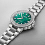 The Oris Aquis Oris X Bracenet is a silver wristwatch with a green mother-of-pearl dial and a matching silver metal bracelet.