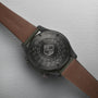 Close-up of the back of an Oris ProPilot Altimeter watch with a brown leather strap, showing technical details and calibre 793 engraved on the black case back.