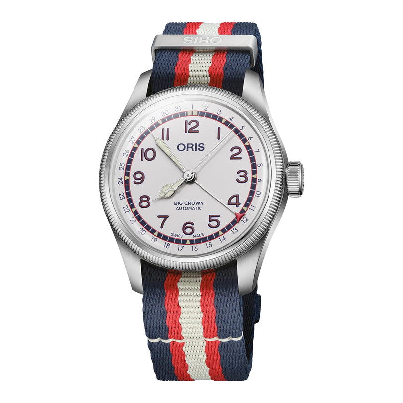 The Oris Big Crown Hank Aaron Limited Edition wristwatch features a stainless steel case, white dial with purple numerals, red/cream/blue striped fabric strap, and Big Crown Automatic text on the watch face.