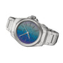 The Oris ProPilot X Calibre 400 Laser is a stainless steel watch with a metallic link band and a blue-purple gradient dial, created by lasering technique and featuring the Oris brand name.