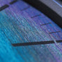 Close-up of the Oris ProPilot X Calibre 400 Lasers iridescent, biomimicry-inspired watch face with a textured surface and minimalist dark hour markers.