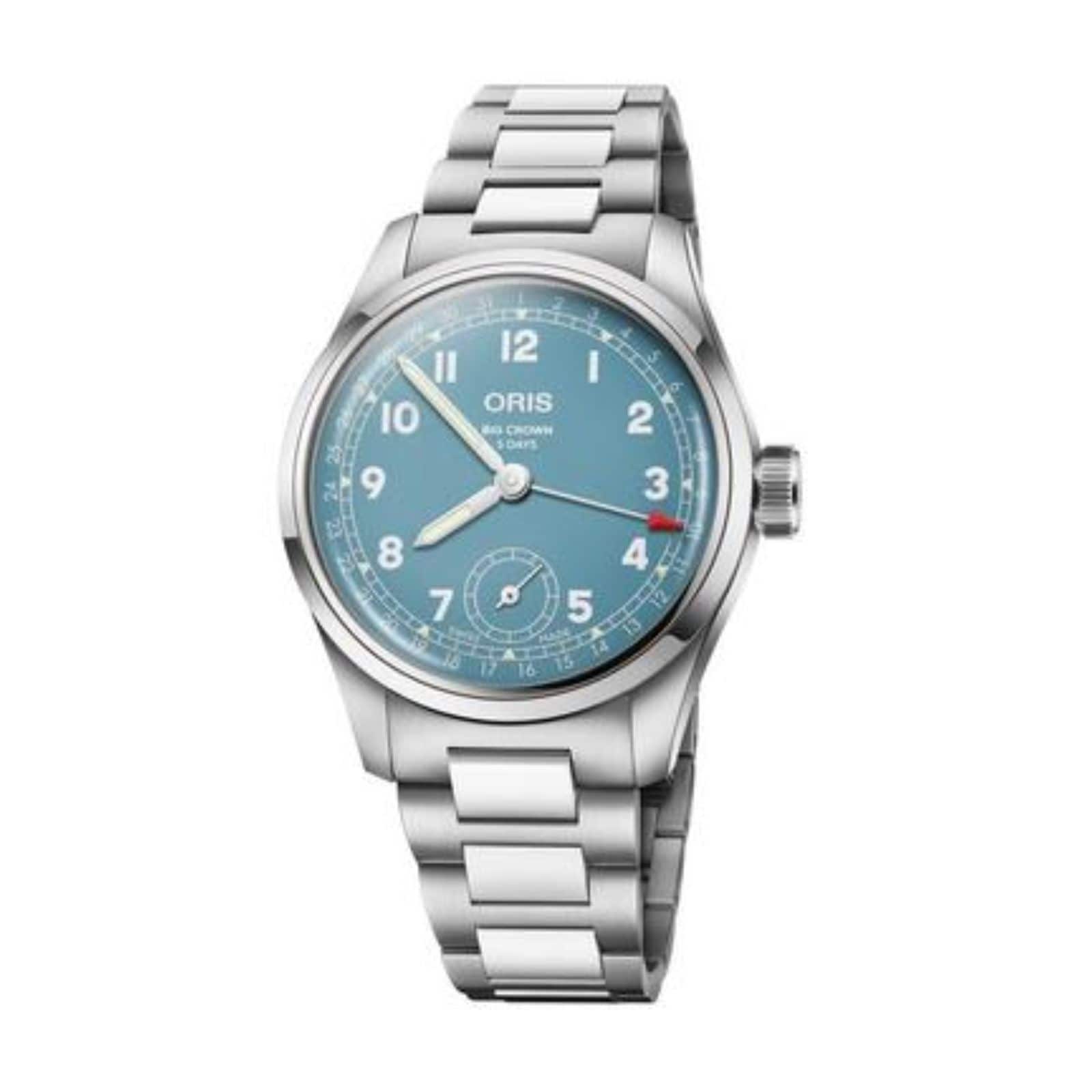 The Oris Big Crown Pointer Date Calibre 473 is a stainless steel wristwatch with a light teal blue dial, white numerals, date window at 6 o’clock, and metal link bracelet.