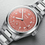 A stainless steel Oris Big Crown Pointer Date Calibre 403 wristwatch with a metal band, terracotta dial featuring Arabic numerals, a date ring, and the brand name on the face.