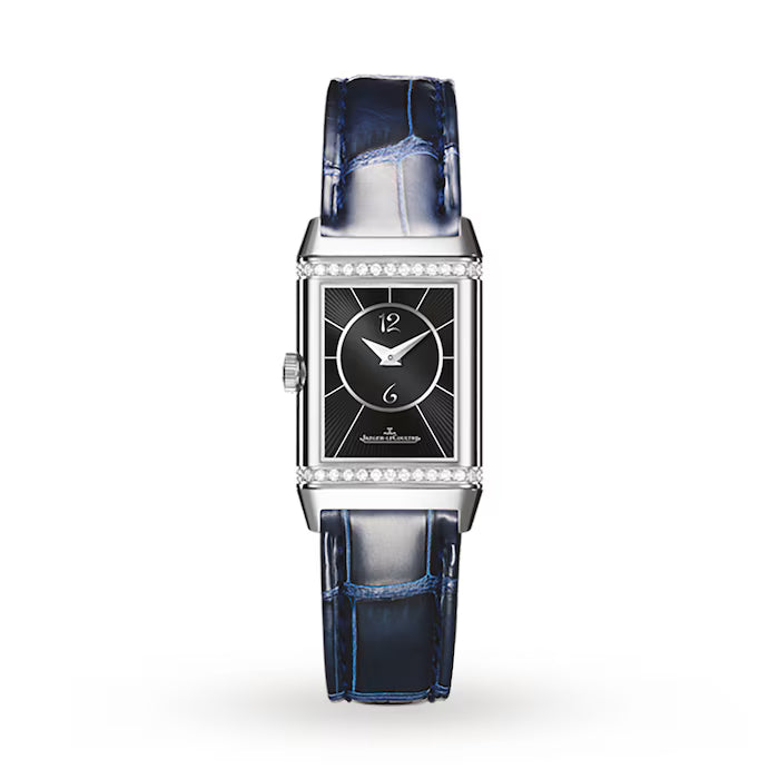 The Jaeger-LeCoultre Reverso Small Duetto is a luxury rectangular wristwatch with a black dial, silver accents, diamond-accented bezel, and blue alligator leather strap, shown on a white background.