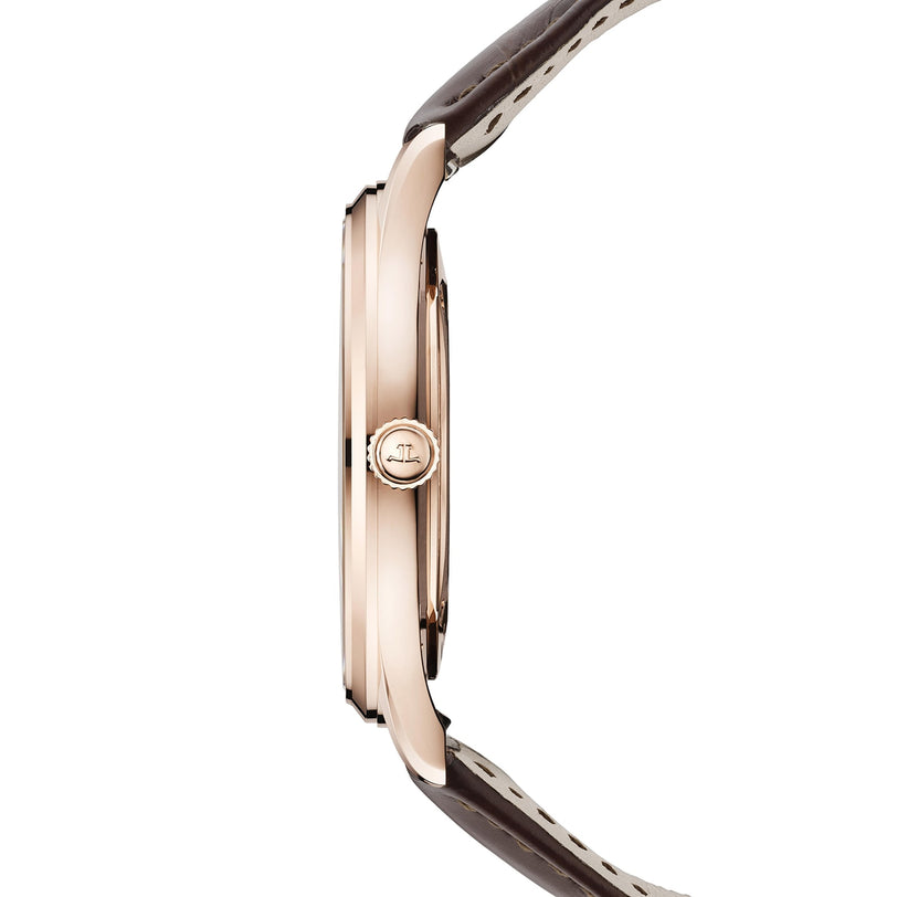 Side view of the Jaeger-LeCoultre Master Ultra Thin Date, a slim pink gold watch with a brown leather strap and logo-engraved crown, featuring an elegant case housing the precise Caliber 899 movement. Watch face not shown.