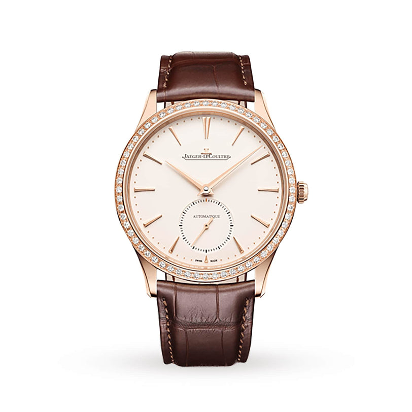 The Jaeger-LeCoultre Master Ultra Thin Small Seconds features a rose gold case, diamond bezel, white dial with gold hour markers, small seconds subdial at 6 o’clock, and a brown leather strap.