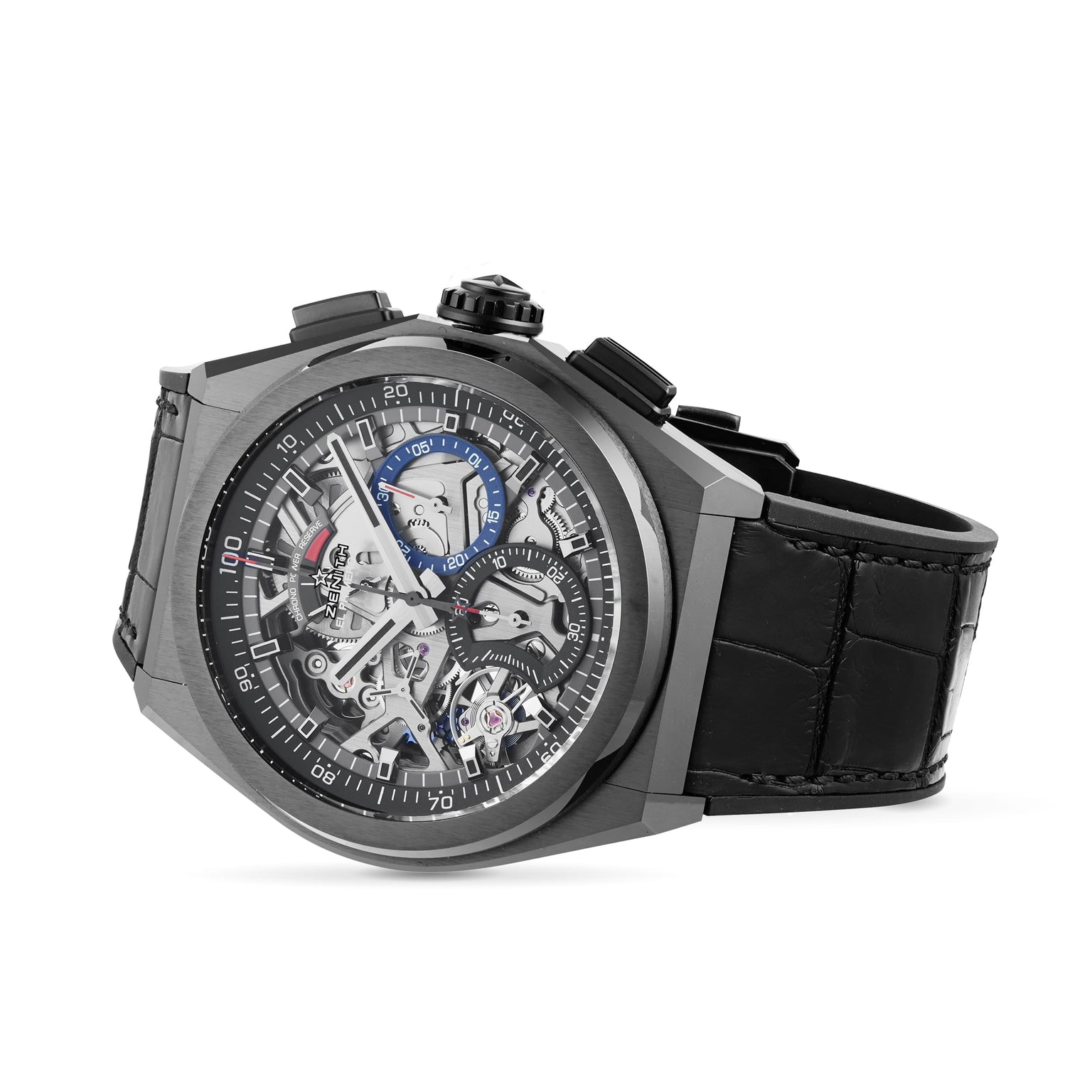 The Zenith Defy El Primero 21 is a luxury skeleton watch with a black leather strap, black bezel, visible gears, and urban design elements accented in blue, red, and white on the dial.