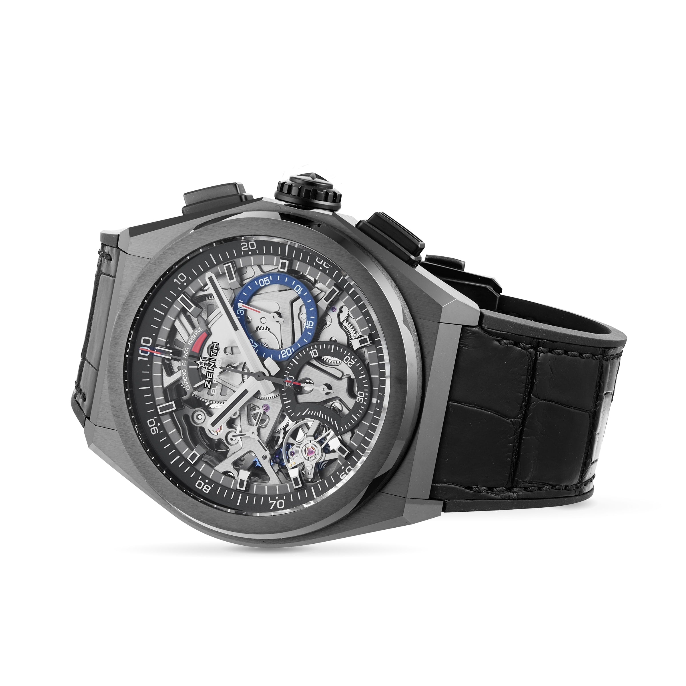 The Zenith Defy El Primero 21 is a luxury skeleton watch with a black leather strap, black bezel, visible gears, and urban design elements accented in blue, red, and white on the dial.