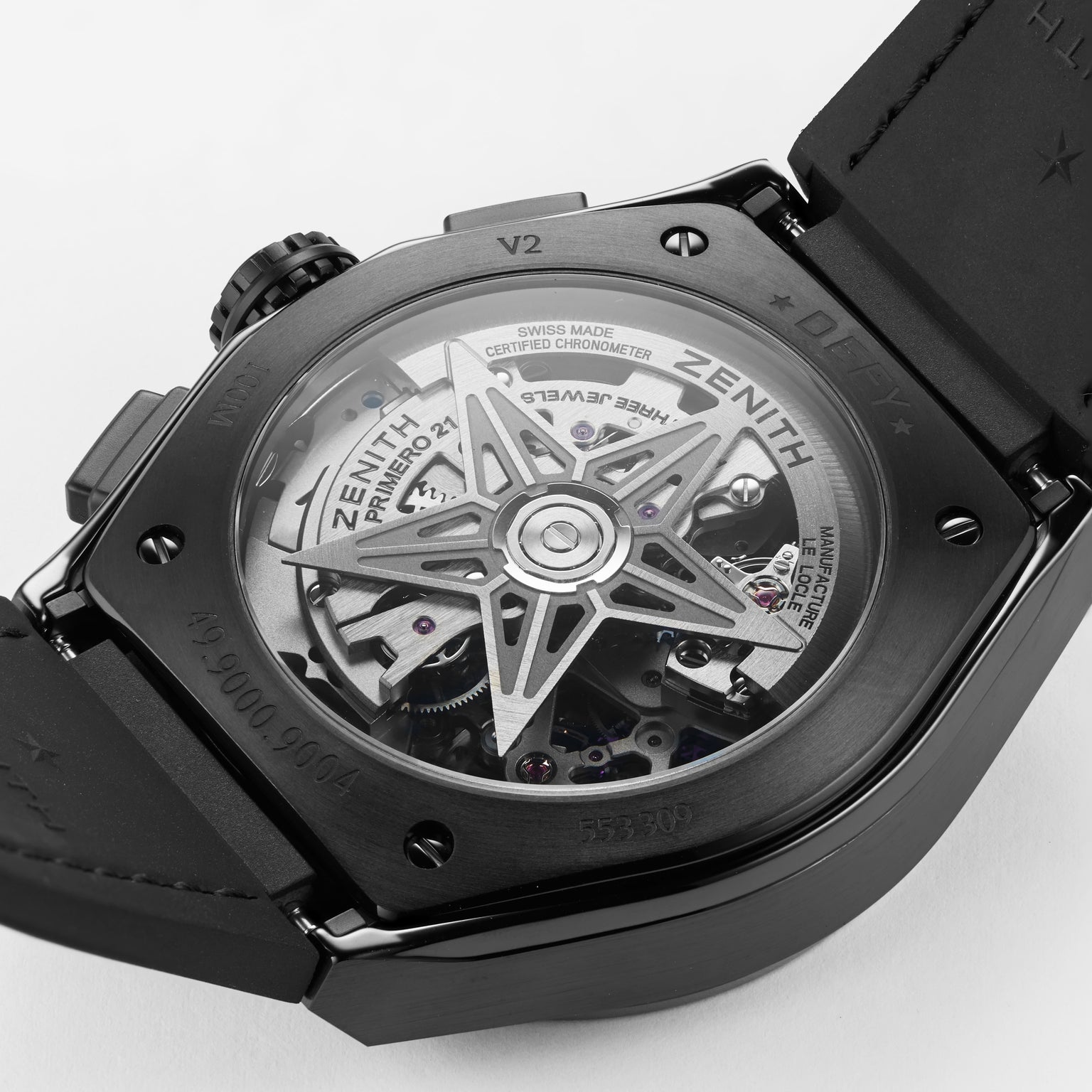 Close-up of the back of the Zenith Defy El Primero 21 wristwatch, showcasing its high-frequency chronograph movement and star-shaped rotor through a transparent case back, embodying Zenith’s bold urban design.