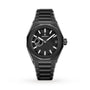 The Zenith Defy Skyline wristwatch features a black patterned dial, silver hour markers, date window at 3 o’clock, and a metal bracelet. It is displayed on a white background.