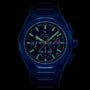 The Zenith Limited Edition Defy Skyline Chronograph 160th Anniversary Edition features a dark blue case, luminescent markers and hands, and a matching metal bracelet, all set against a striking black background.