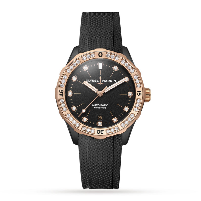 The Ulysse Nardin Diver 39 is a black automatic watch with a diamond-set bezel, diamond hour markers, gold accents, a black textured strap, and a date display at 6 o’clock.