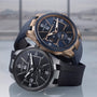 Two luxurious Ulysse Nardin Blast Dual Time watches—one in rose gold and blue, the other in silver and black—feature Roman numeral dials, Dual Time and Home Time functions, set against a softly blurred background.