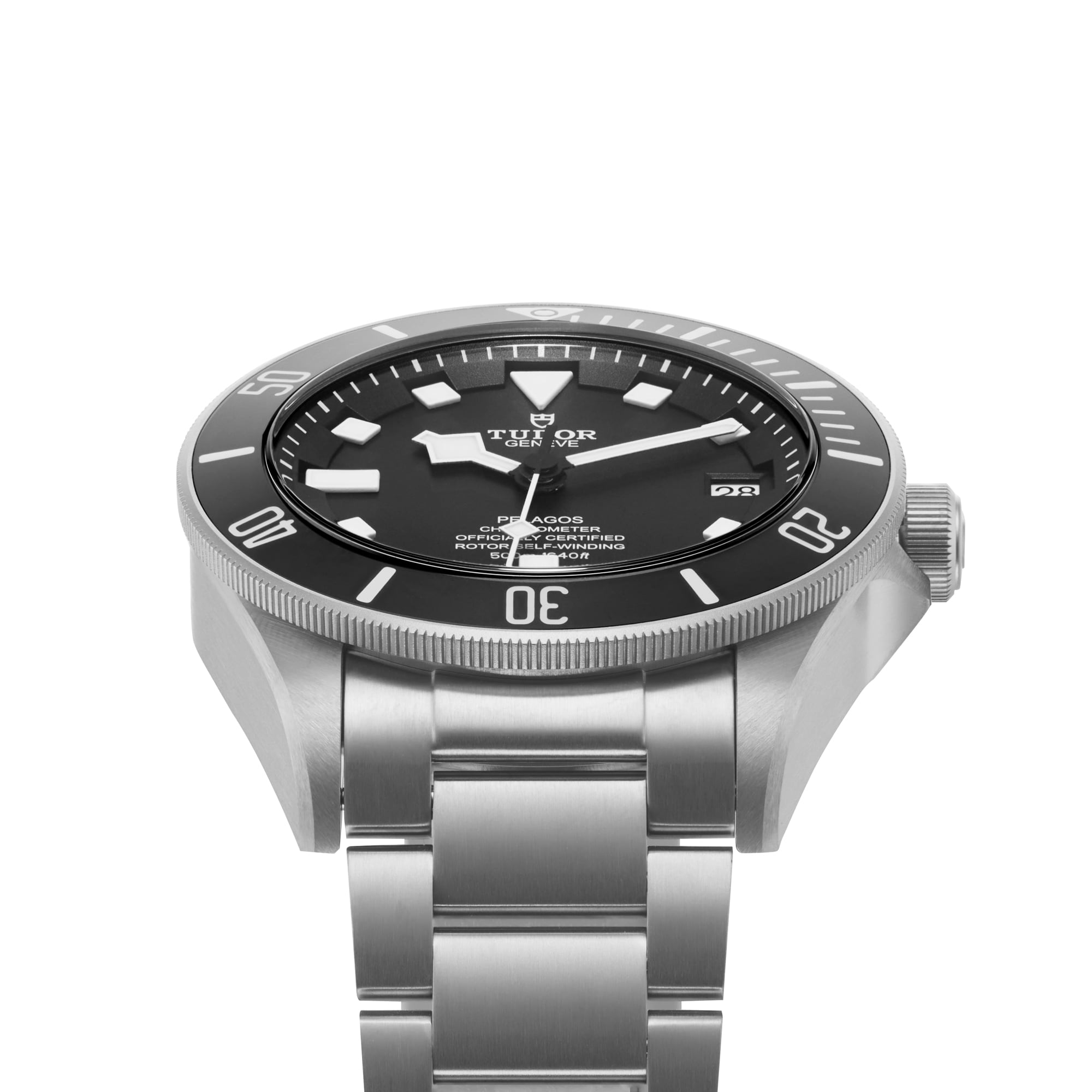 A TUDOR Pelagos stainless steel divers watch with a black dial, luminescent markers, rotating bezel, date window, and metal bracelet is angled to display its side and face.
