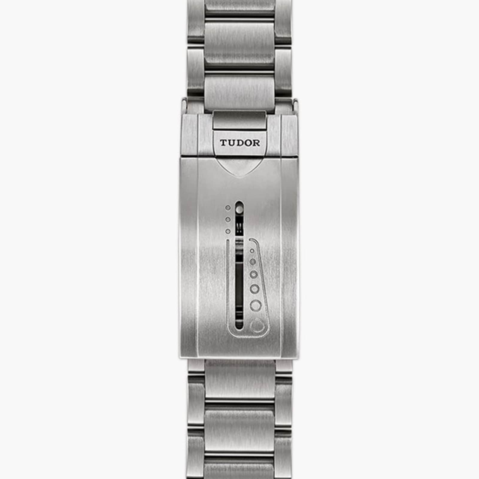 Close-up of a silver TUDOR Pelagos watch clasp featuring an adjustable sliding mechanism and engraved logo.