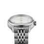 A close-up of the TUDOR 1926, a silver wristwatch with a white textured dial, diamond hour markers, and stainless steel bracelet, featuring a self-winding movement, photographed on a white background.