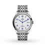 The TUDOR 1926 mens watch features a stainless steel case, white textured dial with blue numerals, date at 3 oclock, and a silver link bracelet—an elegant classic shown on a white background.