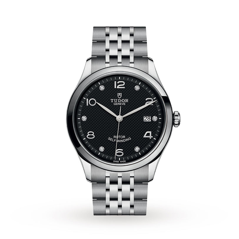 The TUDOR 1926 wristwatch features a stainless steel case, black textured dial, silver markers, date at 3 o’clock, and metal link bracelet—highlighting Hans Wilsdorf’s commitment to fine watchmaking. Shown on a white background.