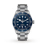 A TUDOR Black Bay 58 dive watch in stainless steel, featuring a blue bezel and dial, luminous markers, and a metal bracelet, shown against a white background.