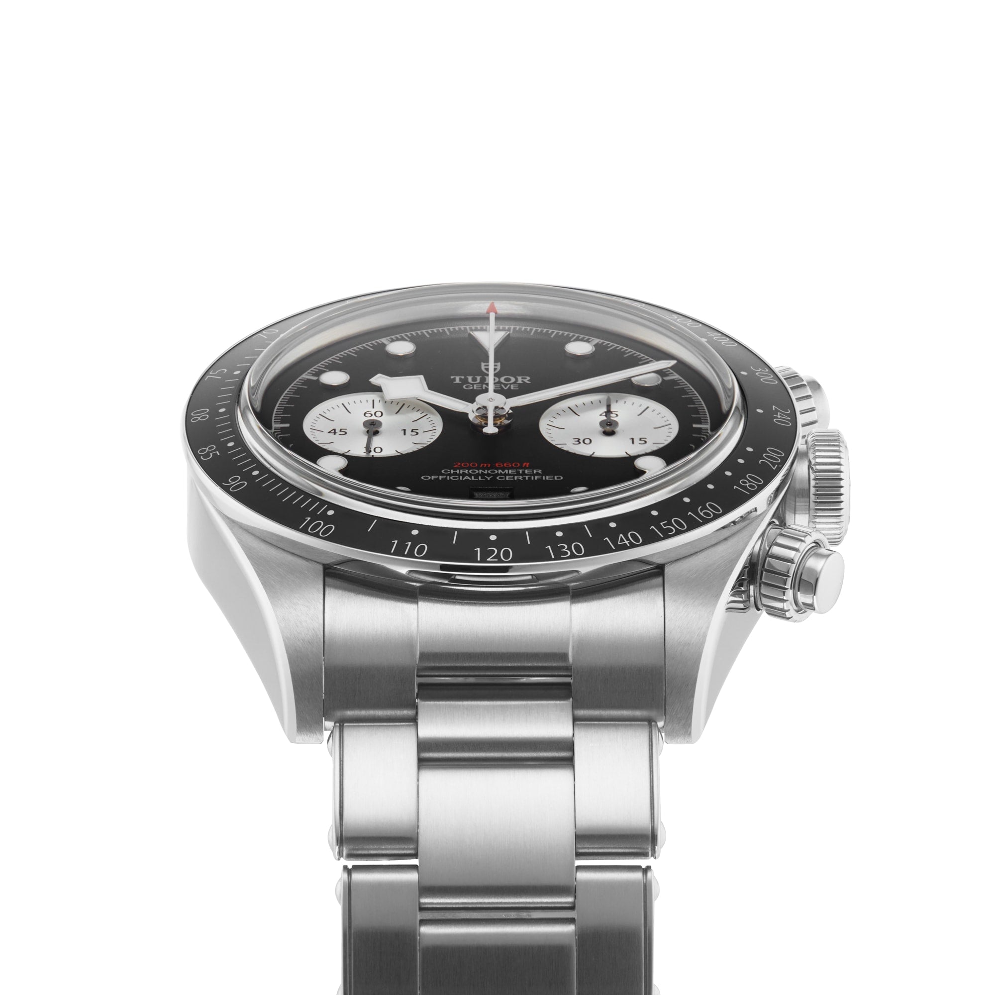 The TUDOR Black Bay Chrono is a stainless steel wristwatch featuring a tachymetric black bezel, black dial, three white subdials, and a metal bracelet, displayed at an angle against a white background.