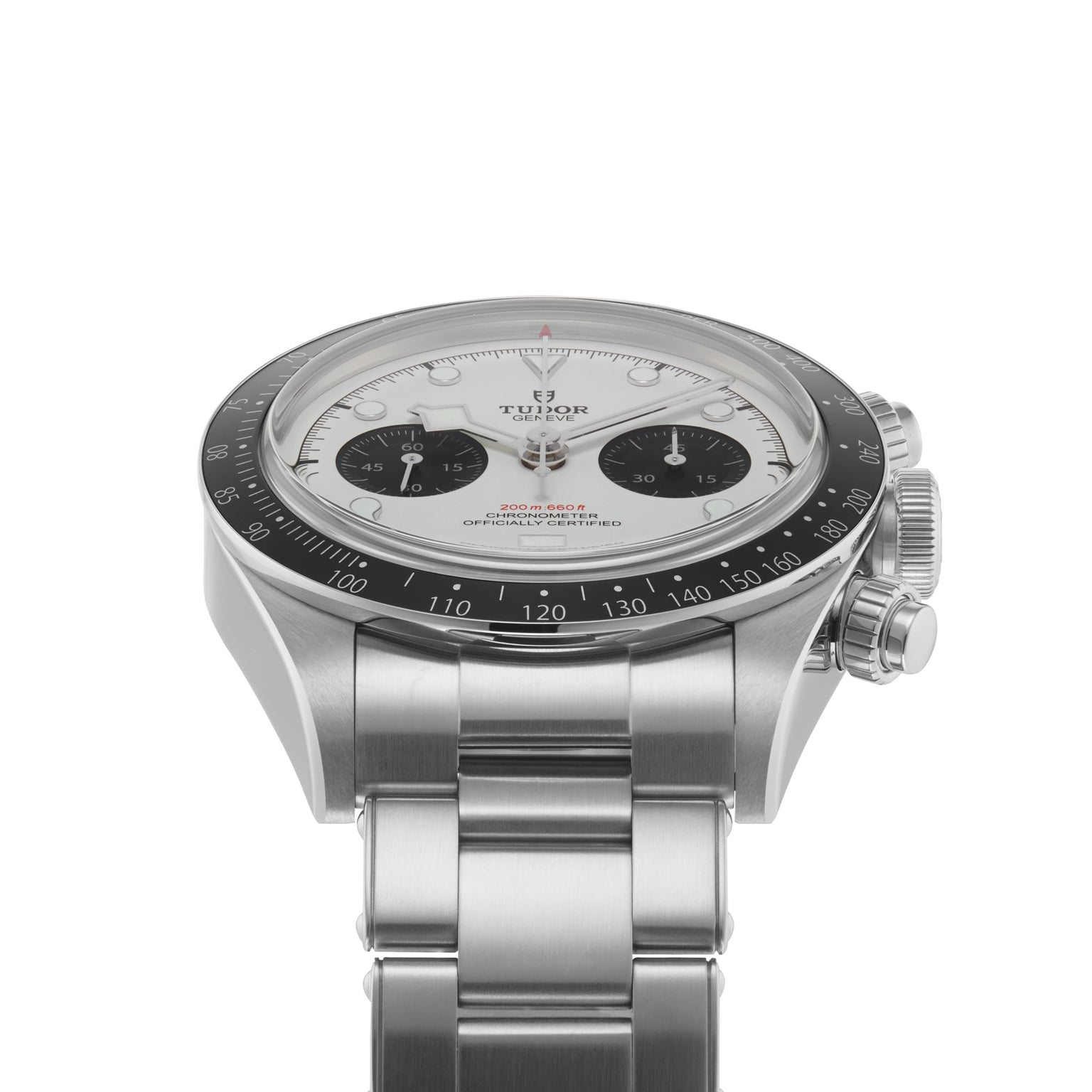 The TUDOR Black Bay Chrono, a stainless steel chronograph wristwatch with a white dial, black subdials, and a black tachymeter bezel, is shown angled on its metal bracelet.