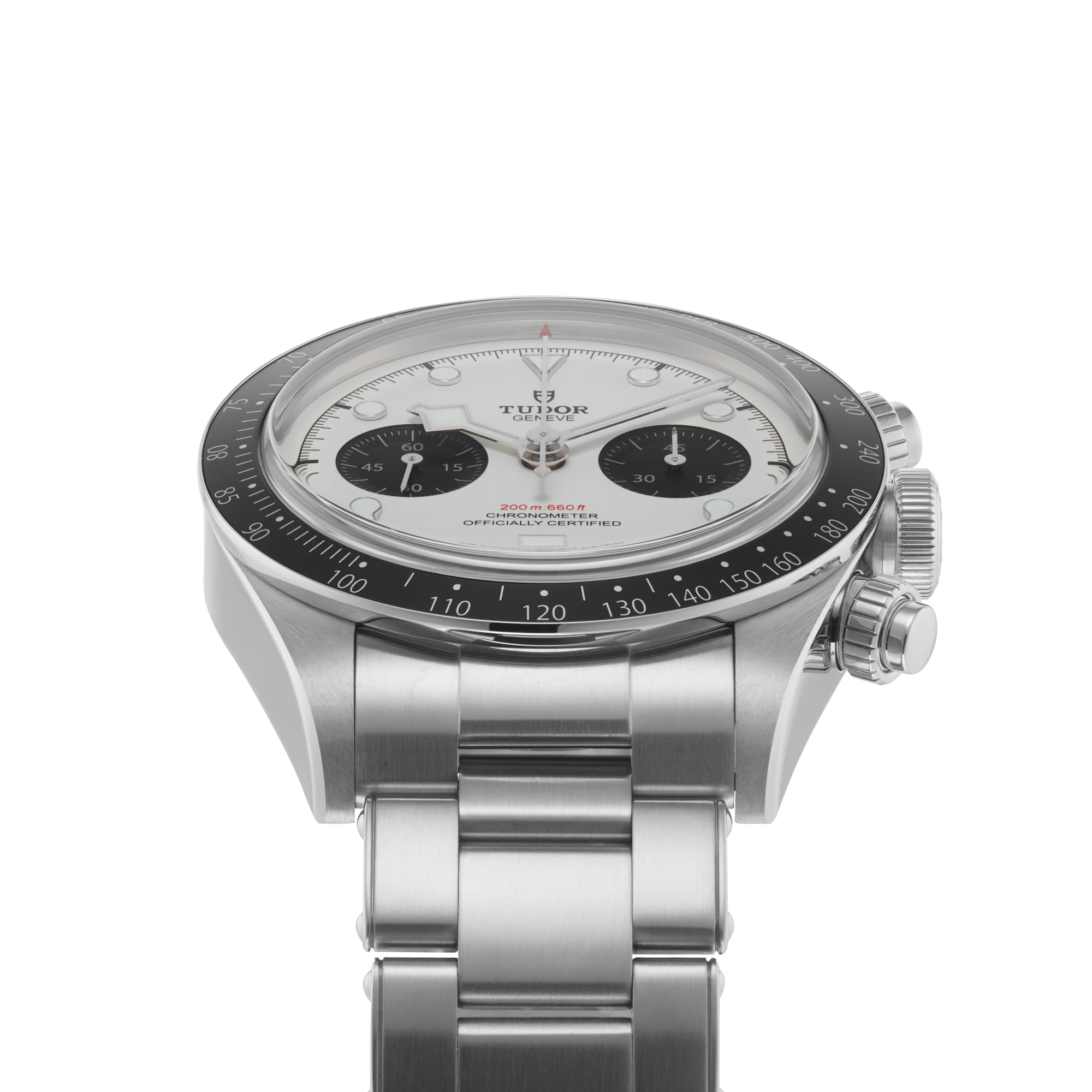 The TUDOR Black Bay Chrono, a stainless steel chronograph wristwatch with a white dial, black subdials, and a black tachymeter bezel, is shown angled on its metal bracelet.