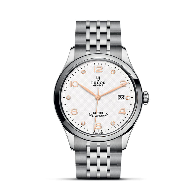 The TUDOR 1926 is a stainless steel wristwatch featuring a white textured dial, gold-tone hands and markers, a date window at 3 o’clock, and a silver link bracelet—a classic from the renowned TUDOR collection.