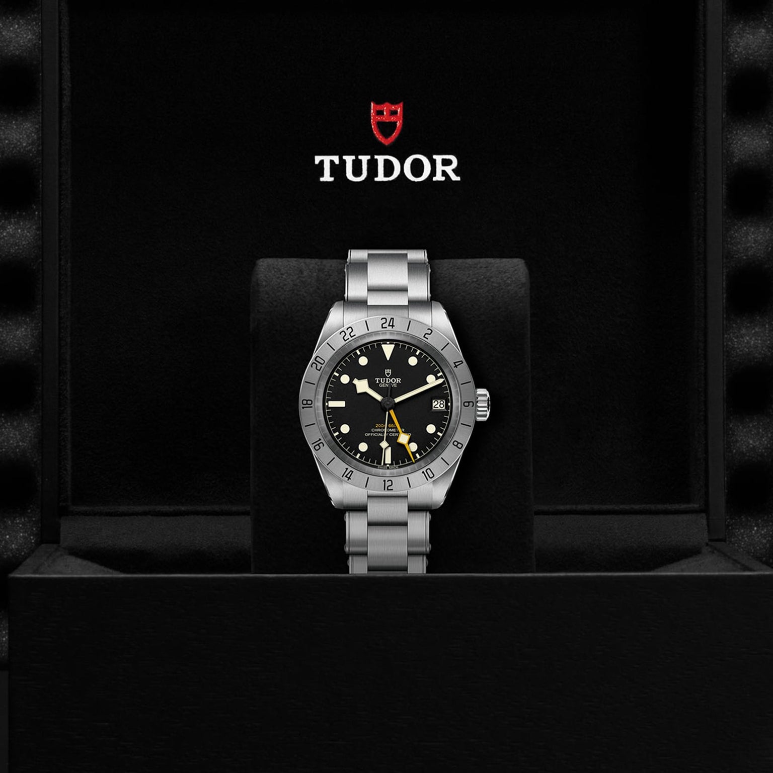 A TUDOR Black Bay Pro wristwatch displayed in an open black box with the TUDOR logo above it.