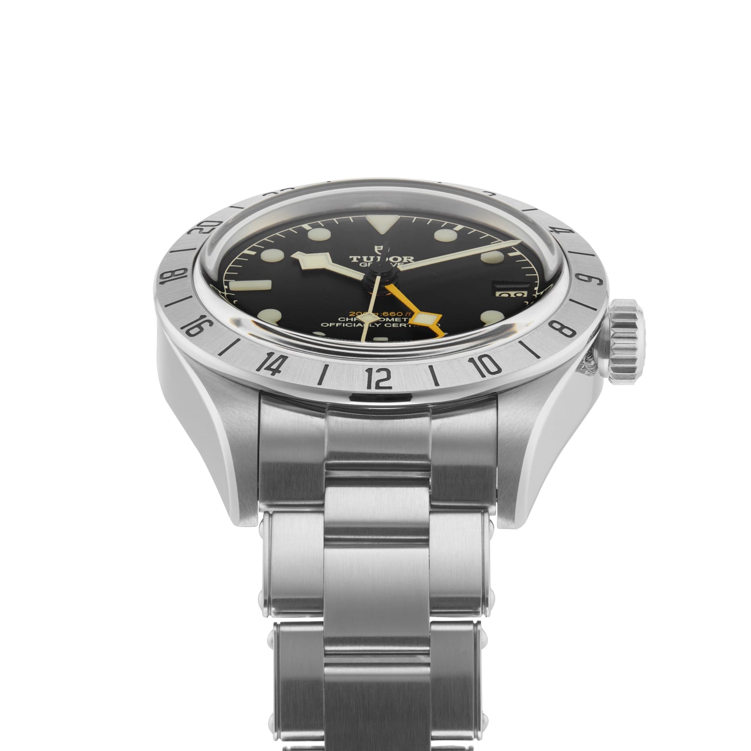 The TUDOR Black Bay Pro, a stainless steel wristwatch with a black dial, silver bezel, and metal bracelet, is displayed at an angle against a white background, showcasing the modern craftsmanship of TUDOR’s diver watches.