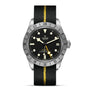 The TUDOR Black Bay Pro is a neo-vintage wristwatch with a black dial, date window, stainless steel bezel, and a black leather strap accented by a yellow center stripe, inspired by the iconic Black Bay collection.
