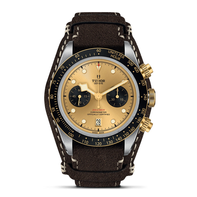 The TUDOR Black Bay Chrono S&G features a gold and black dial with two subdials, gold hands, a black bezel, and a brown leather strap—a standout automatic sport-chic watch from the iconic TUDOR collection.
