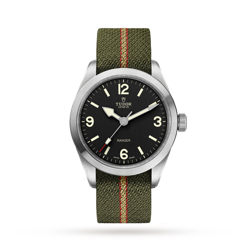 The TUDOR Ranger wristwatch features a black dial with Arabic numerals and an olive green jacquard strap with a red stripe, perfectly capturing the adventurous spirit of the Ranger collection.