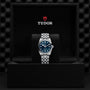 A TUDOR Black Bay One 31 silver wristwatch with a blue dial, displayed in an open black TUDOR watch box.