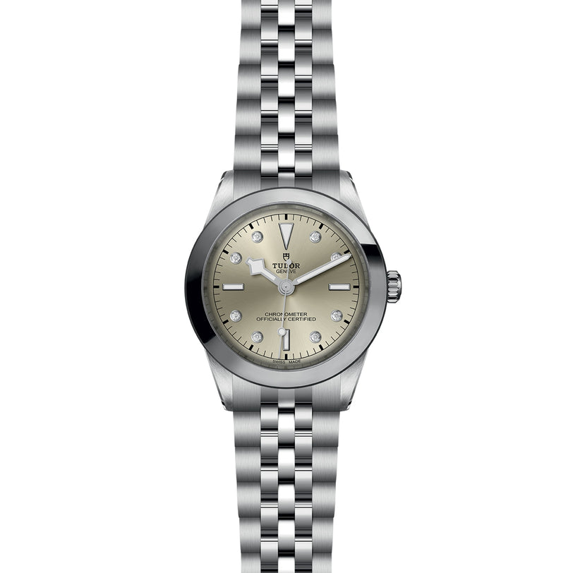 The TUDOR Black Bay One 39 is a unisex stainless steel wristwatch featuring a silver dial with diamond hour markers, baton hands, and a 316L steel bracelet that embodies the timeless elegance of the Black Bay collection.