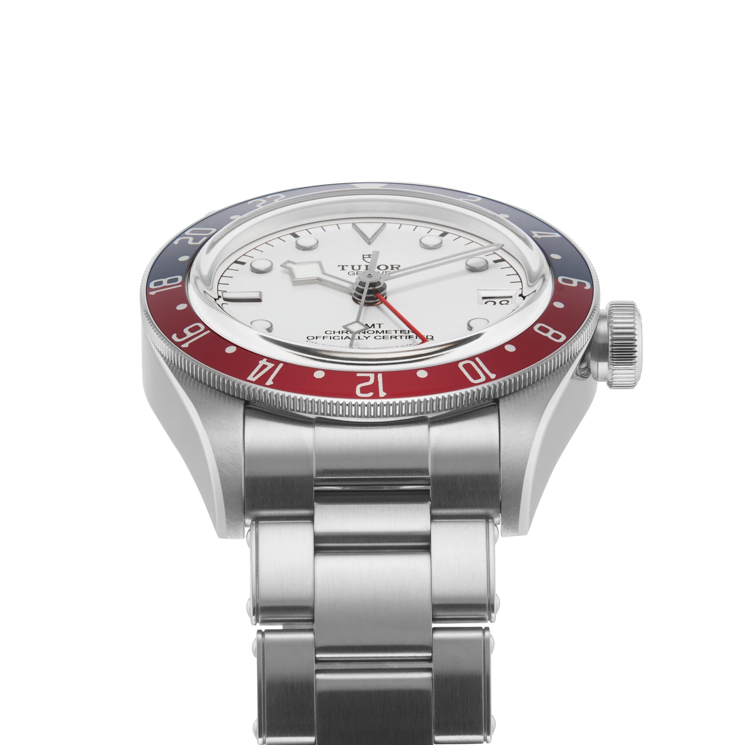 A TUDOR Black Bay GMT wristwatch with a red and blue bezel, opaline dial, and silver bracelet, shown from a low angle.