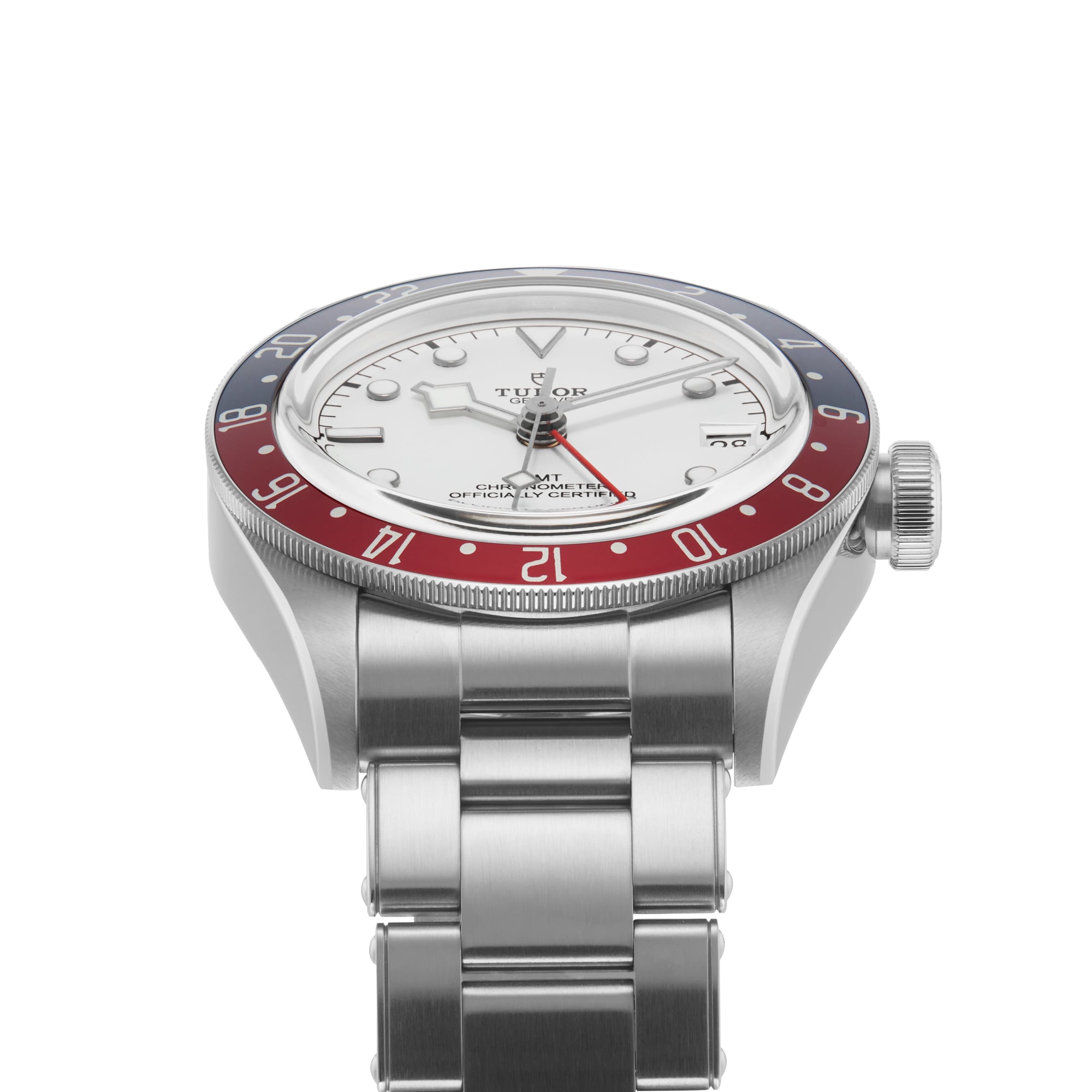 A TUDOR Black Bay GMT wristwatch with a red and blue bezel, opaline dial, and silver bracelet, shown from a low angle.