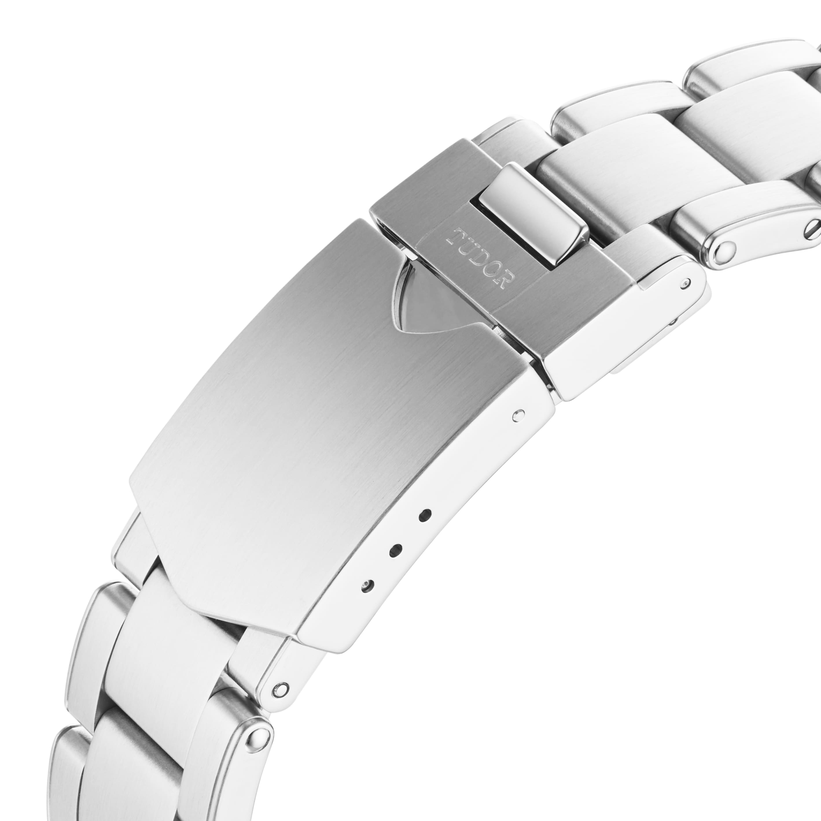 Close-up of the TUDOR Black Bay GMTs silver metal bracelet with a branded clasp, highlighting its brushed and polished links.