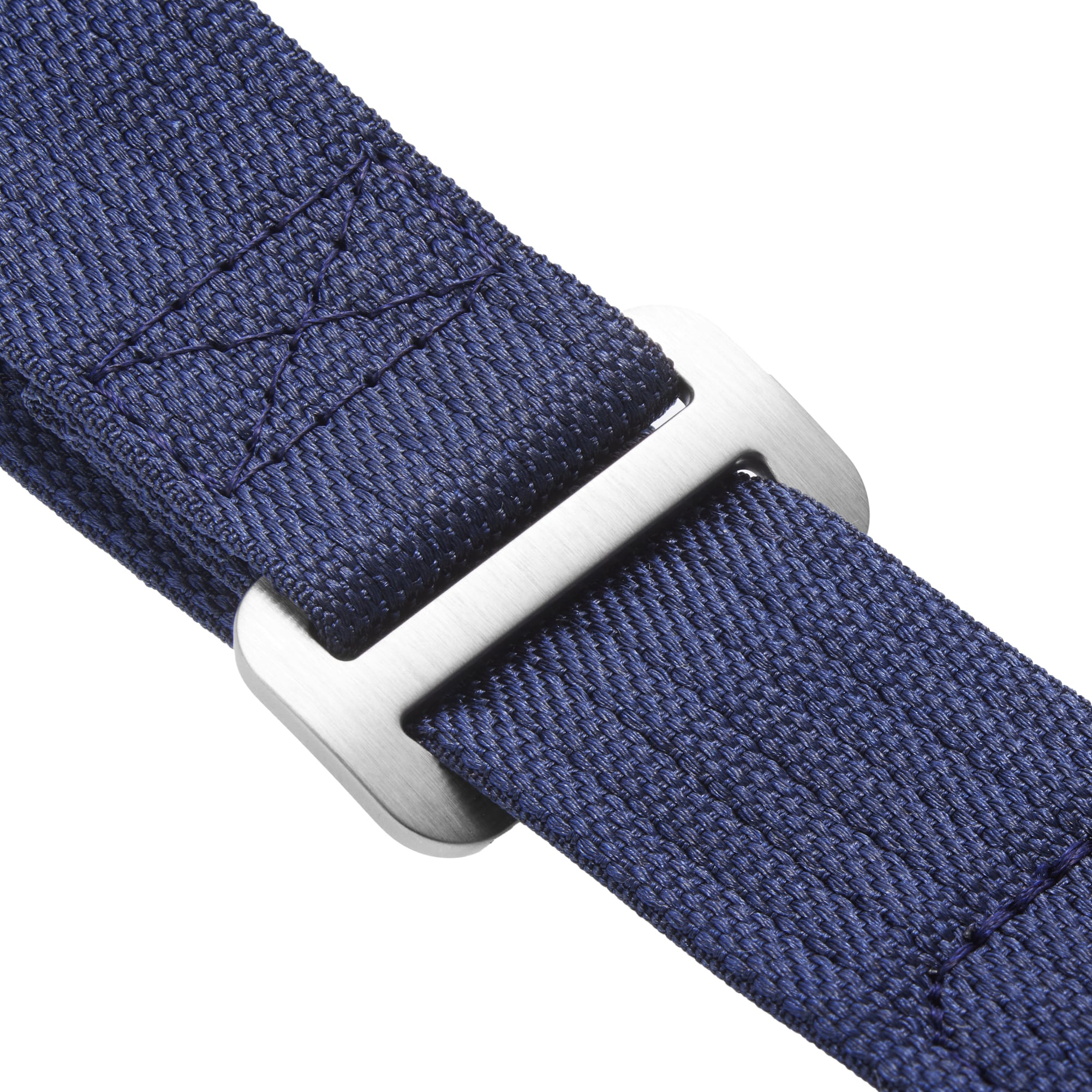 Close-up of a navy blue woven fabric strap by TUDOR, made for the Pelagos FXD, threaded through a rectangular silver buckle—engineered for superior waterproof performance and underwater navigation.