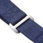 Close-up of a navy blue woven fabric strap by TUDOR, made for the Pelagos FXD, threaded through a rectangular silver buckle—engineered for superior waterproof performance and underwater navigation.