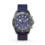 The TUDOR Pelagos FXD Chrono is a blue dive watch with a fabric strap, black bezel, and red accents on the dial and strap.