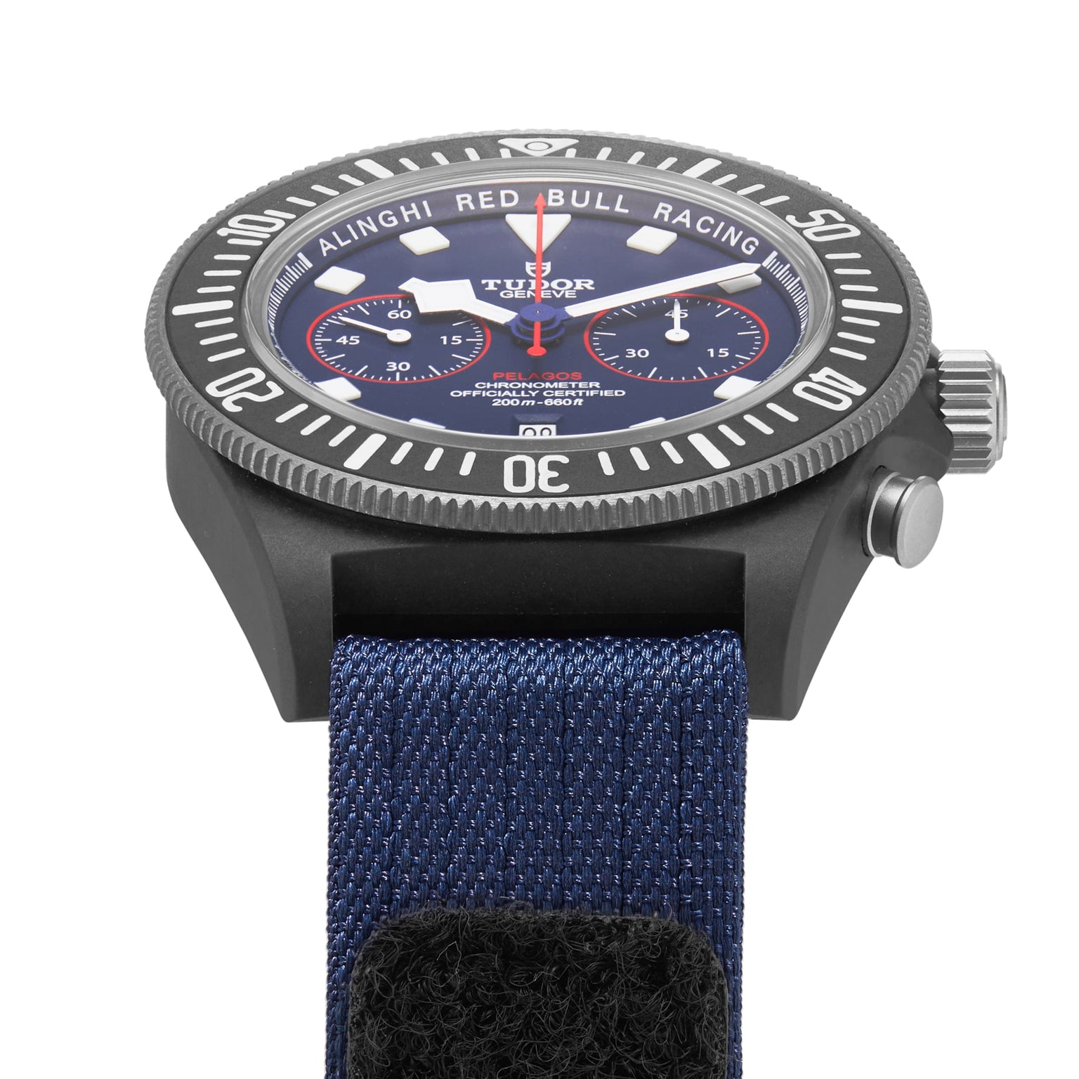 A close-up of a TUDOR Pelagos FXD Chrono wristwatch featuring a blue fabric strap and a black bezel.