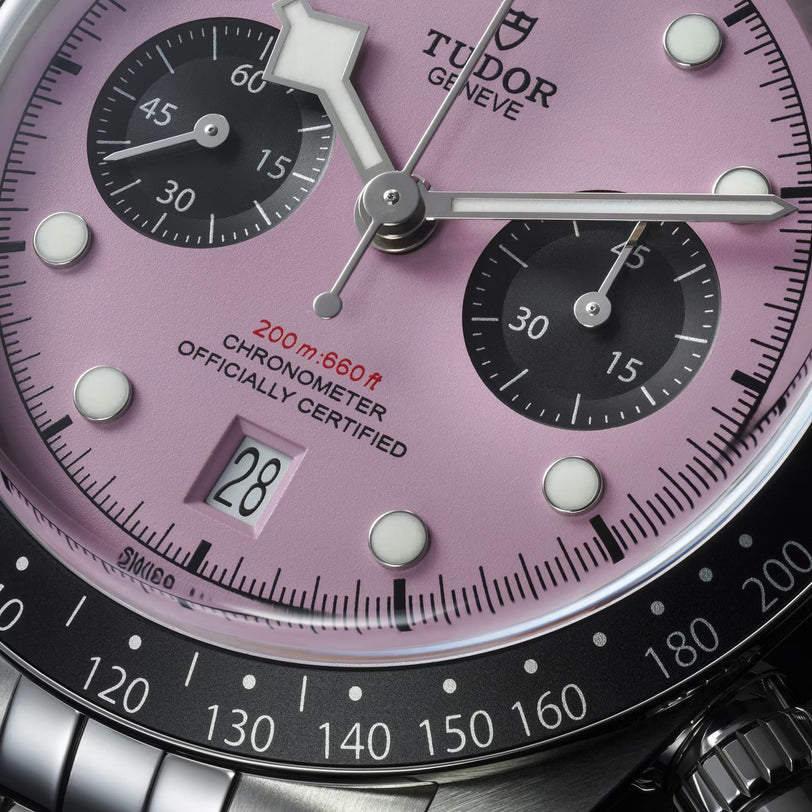 Close-up of the TUDOR Black Bay Chrono, showing its bold pink dial, black subdials, date at 6 o’clock, and stainless steel case. Swiss Chronometer Certified with 200m (660ft) water resistance.