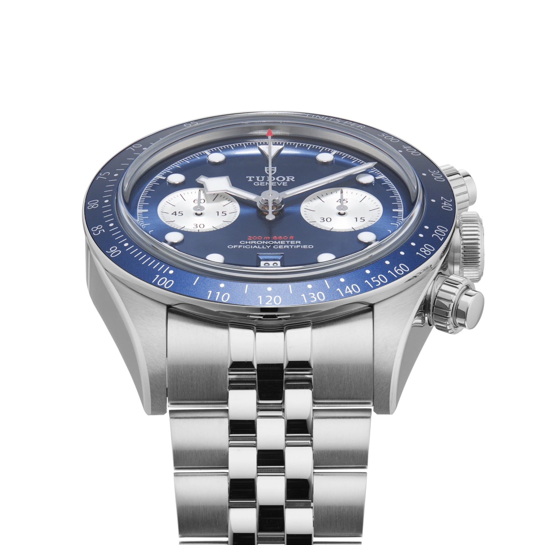 The TUDOR Black Bay Chrono stainless steel wristwatch features a blue bezel, blue dial with white subdials, and a metal bracelet. Shown angled and offered exclusively at Tudor Boutiques.