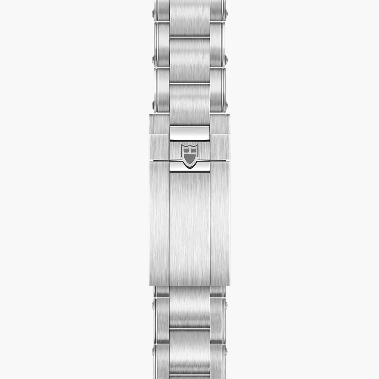 The TUDOR Black Bay 58 features a silver metal watch bracelet with a clasp showcasing an engraved shield logo at the center.