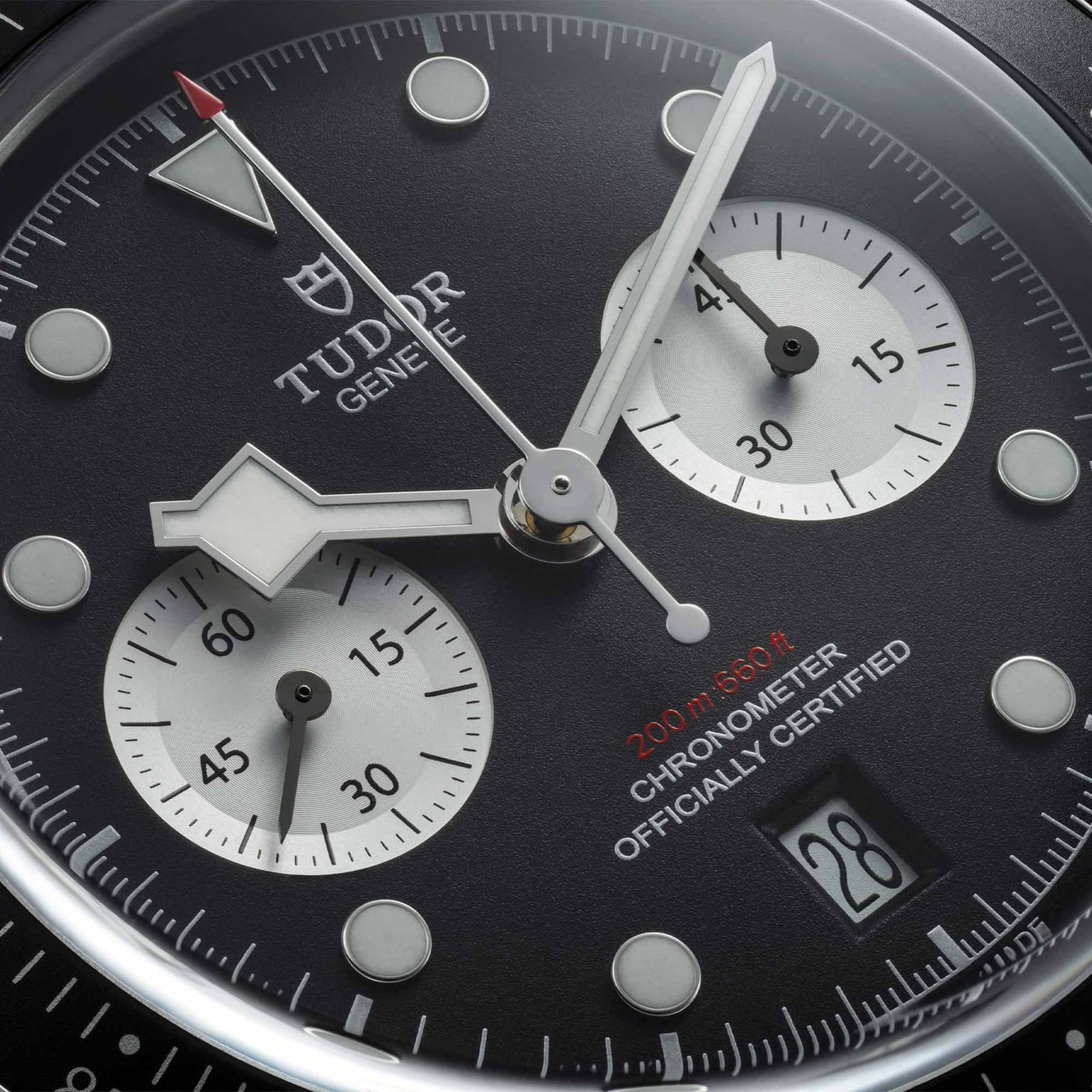 Close-up of the TUDOR Black Bay Chrono watch face featuring two subdials, a date window, and 200m water resistance text.